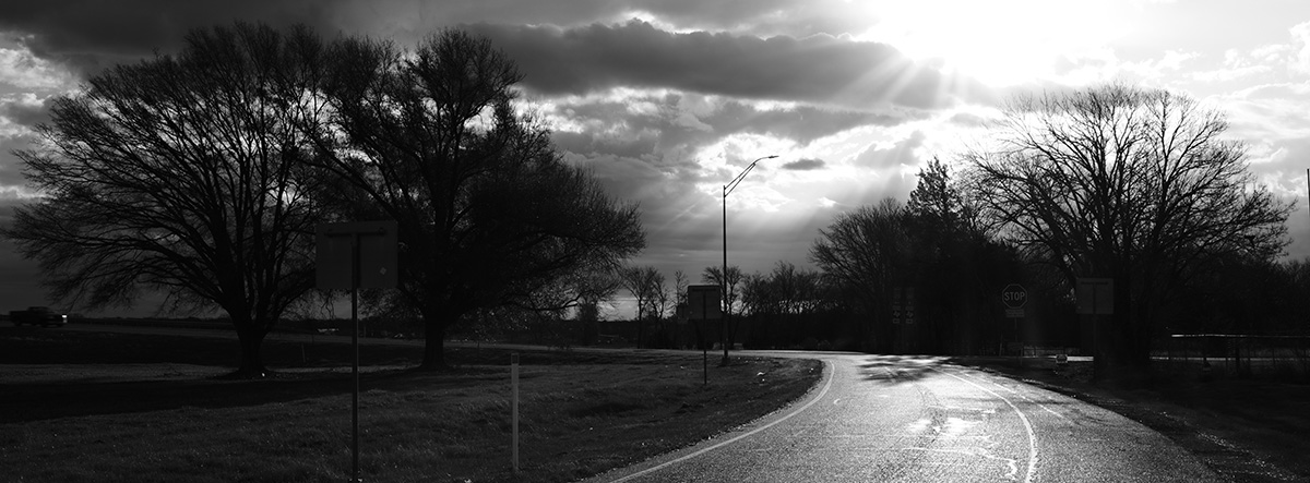 Black and White photography of sunlight breaching through the clouds out in East Texass