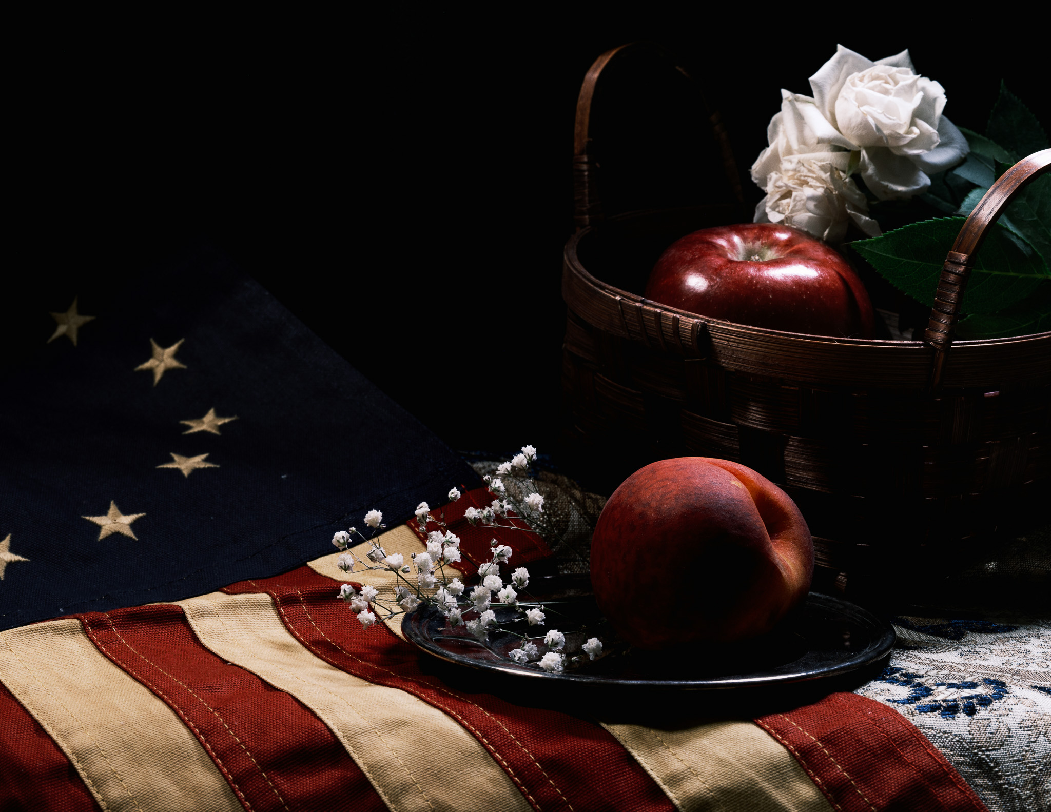 Still-life photography of a texas flag, apple, and golden cloth
